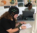 PhD student monitors the brain activity of volunteers listening to music at festival